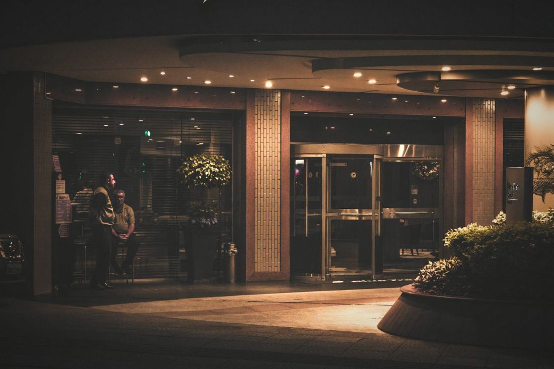 Lit entrance of a high-end venue after dark